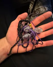 Telegram message from Andrew with a photo of his hand holding handmade purple bracelets